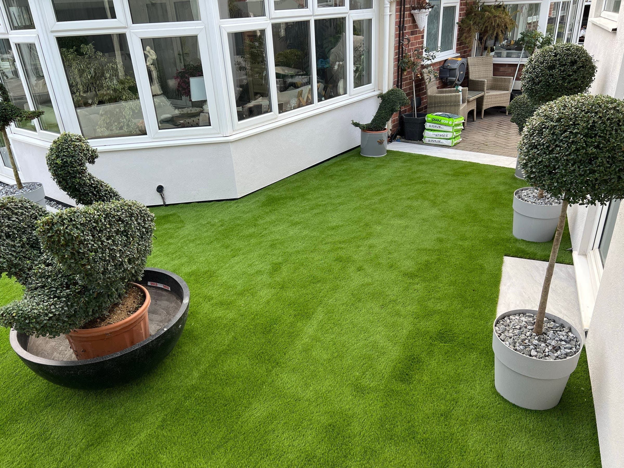 Outdoor space with artificial grass and paving